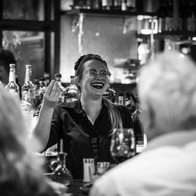 A bartender at Valentina's Italian chats with guests behind the bar