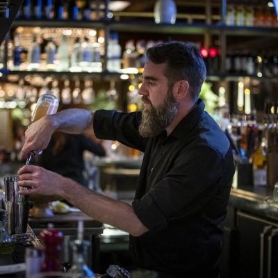 A bartender at Valentina's Italian prepares drinks behind the bar