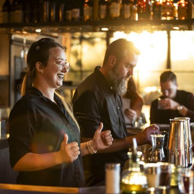 Bartenders at Valentina's Italian prepare drinks and chat with guests behind the bar