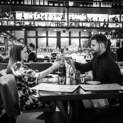 Two guests toast with glasses of wine at Valentina's Italian