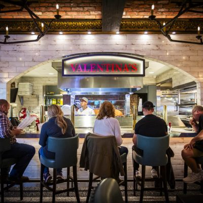 Five guests sit in front of the kitchen at Valentina's Italian.