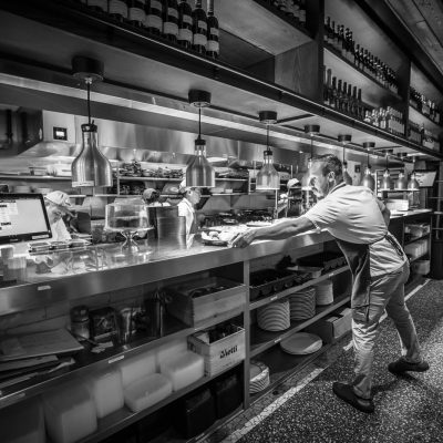 Servers pick up dishes from the expo line at Valentina's Italian