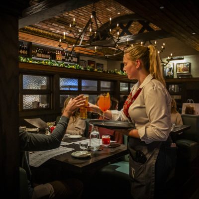 A server at Valentina's delivers drinks to guests in the dining room