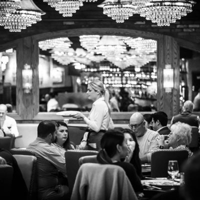 A server at Valentina's delivers food to guests in the dining room