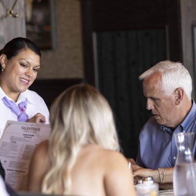 Server smiling at guest as orders are received at Valentina's restaurant at Bridge Park in Dublin, Ohio.