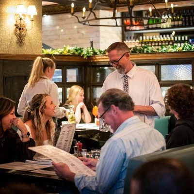 Valentina's server taking guest order in the dining room.